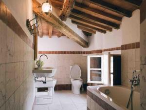 a bathroom with a tub and a toilet and a sink at Villa Bianca charming Tuscany house with pool in Lucca +72 photos