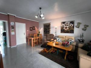 a living room with a couch and a table at Bungalow Malibu Complex Doa Pepa- Rojales in Ciudad Quesada