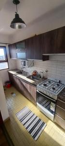 a kitchen with a stove and a sink at Libertador in Posadas