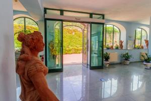 a statue of a woman in front of a glass door at Parco dei Principi Resort & Spa in Forio d'Ischia +136 photos