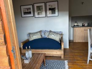 a bedroom with a blue bed and a table at Klein Karoo Game Lodge in Oudtshoorn