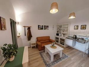 a living room with a couch and a table at Etela Old Town Apartment in Košice