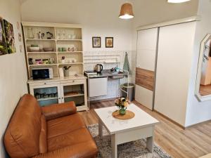 a living room with a couch and a table at Etela Old Town Apartment in Košice +15 photos