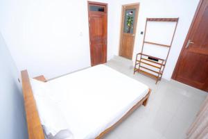 Postel nebo postele na pokoji v ubytování Kandy Grand Hill