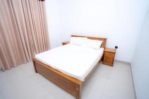 Postel nebo postele na pokoji v ubytování Kandy Grand Hill