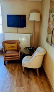 a living room with a couch and a chair at Aux coeurs du Méjean in Mas Saint-Chély