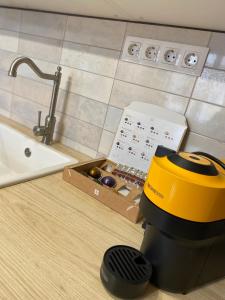 a kitchen counter with a juicer and a sink at Paris - Szeged City Center in Szeged