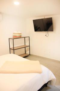 a bedroom with a bed and a flat screen tv at Urban Oasis Med in Medellín