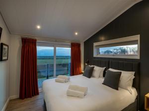 a bedroom with a large bed with a large window at 2 Bed in St Andrews 72436 in Anstruther +26 photos