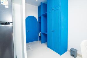 a room with blue cabinets and a refrigerator at Sichon sunrise beach villa in Ban Plai Thon +90 photos
