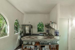 a kitchen with a sink and a stove at Ecosoul Bugambilia villa in Puerto Vallarta