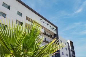 a building with a sign on the side of it at Courtyard by Marriott Hermosillo in Hermosillo +45 photos