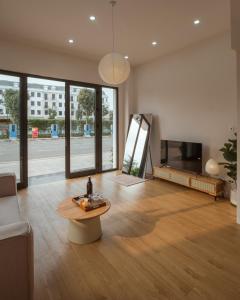 a living room with a couch and a coffee table at Homestay & Hotel Concept Maison in Quang Tri +77 photos