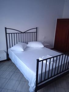 a bed with white sheets and pillows in a bedroom at André Pereira in Ponta do Sol +3 photos