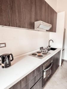 a kitchen with a stove and a sink at apartamento campestre con terraza in Puerto Varas