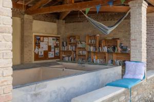 a library with a bench and a book shelf at Les Oliviers - Le Chant des Tongs in Salazac