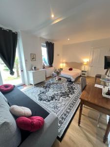 a living room with a bed and a table at La cigale et la fourmi savoisienne - chambre chez l habitant in Aix-les-Bains