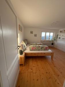 a bedroom with a bed and a wooden floor at Joy's Ferienwohnung in Lütschenbach