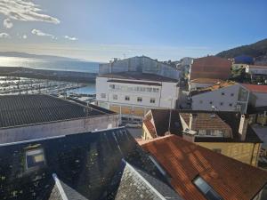 an aerial view of a city with buildings and the ocean at Hotel Mariquito in Finisterre