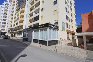 a building on the side of a city street at Rio a Vista Praia da Rocha Flat in Portimão