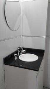 a bathroom with a sink and a mirror on a counter at Estudio Urbano in Santa Rosa