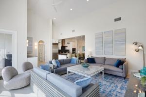 a living room with two couches and a table at Casa Captiva - Deluxe 5 Bedroom Villa Steps to Beach in Captiva