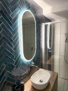 a bathroom with a sink and a mirror at Urban Nest Apartment in Dunajská Streda +15 photos