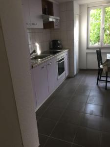 a kitchen with a sink and a stove top oven at Apartement with selfcatering in Buchs