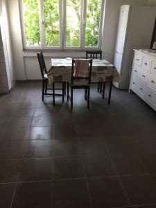 a dining room with a table and chairs on a tile floor at Apartement with selfcatering in Buchs +2 photos