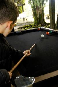 a young boy playing pool on a pool table at Cabana in Santo André +24 photos