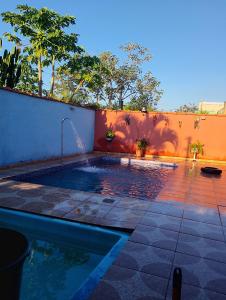 a swimming pool with a fountain in a backyard at Chácara paraíso in Tremembé