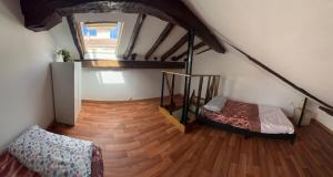 a attic room with a bed and a wooden floor at Apartamento casco viejo in Castro-Urdiales