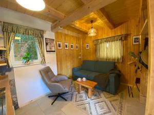a living room with a couch and a table at Princess Mojca Holiday House in Bled