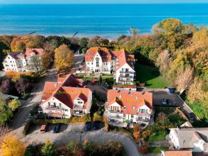 an aerial view of a large house with orange roofs at Haus Seeblick Steuerbord in Insel Poel +16 photos