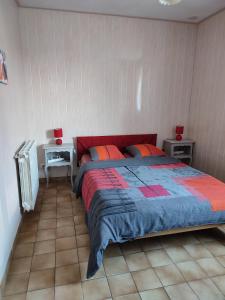 a bedroom with a large bed and two night stands at hortensia 8 in Saint-Étienne-de-Mer-Morte +2 photos