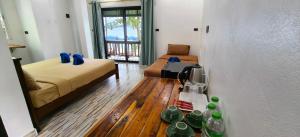 a room with a bed and a table with cups on the floor at Yuyu Golden Beach in Ko Chang