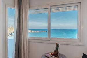 a window with a view of the ocean at Flèria Seaview Suites in Naxos Chora