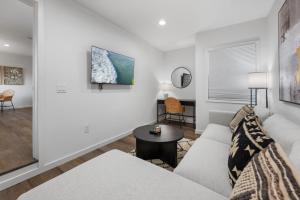 ein Wohnzimmer mit Sofa und Tisch in der Unterkunft South O Bungalow 11 - Luxury King Suite + Patio in Oceanside