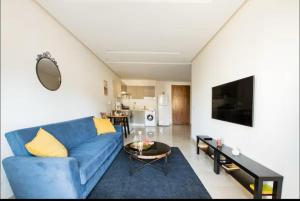 a living room with a blue couch and a table at Tranquil in Casablanca