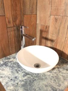 a white sink sitting on a counter in a bathroom at Departamentos Los Robles in Comodoro Rivadavia