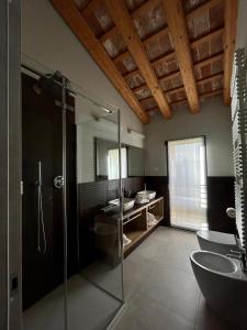 a bathroom with a glass shower and a sink at Ida Boutique Hotel in Casa Marcolin