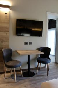 a table and two chairs in a room at Ida Boutique Hotel in Casa Marcolin +47 photos