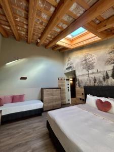 a bedroom with two beds and a painting on the wall at Ida Boutique Hotel in Casa Marcolin