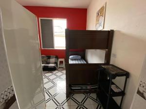 a small room with a bunk bed in it at Kitnet funcional perto da praia Ocian! in Samaritá