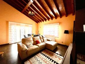 a living room with a couch and a table at Chalet Huerta de Cañamal - Llanes in Llanes