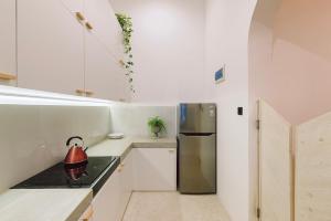 a kitchen with a refrigerator and a tea kettle on the stove at 2 Bedroom Apartment, Colombo 6 in Wellawatta