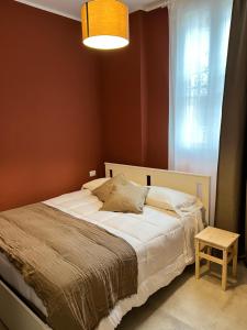 a bedroom with a bed and a lamp and a table at San Siro FB16 in Milan