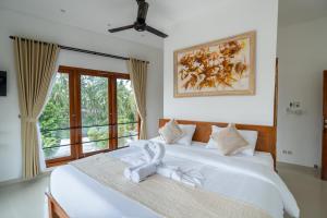 Postel nebo postele na pokoji v ubytování Lemon Tree Hotel Bali