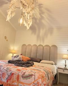 a bedroom with a bed with a gray head board at Chalet Maurice in Zutendaal +34 photos