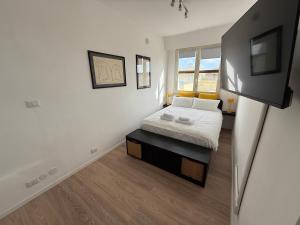 a bedroom with a bed and a television in it at Maison Circe - Boutique Apartment in Latina